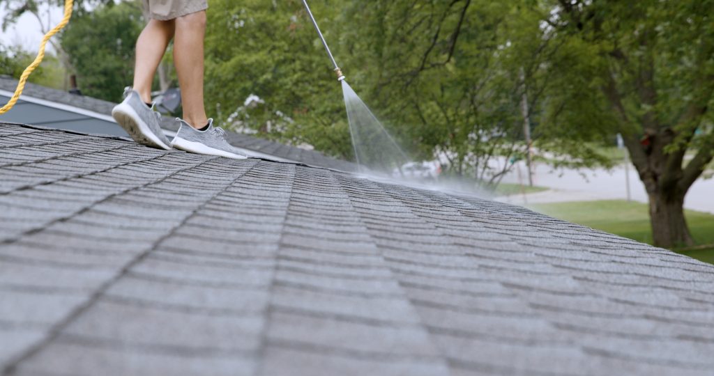 Roof Renew technician applying Peak 301 to an asphalt shingle roof in Utah