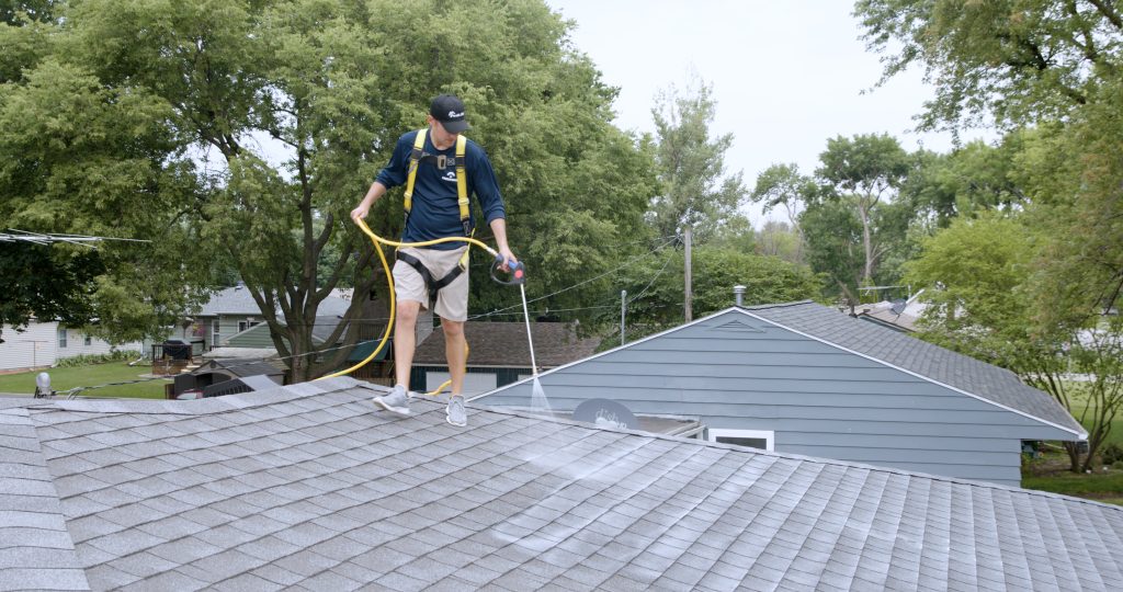 Roof Renew technician applying Peak 301 to an asphalt shingle roof in Utah